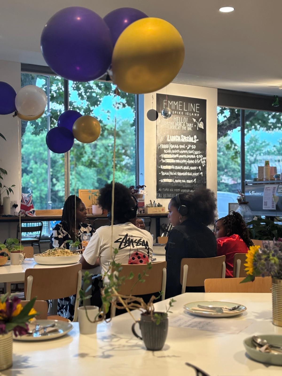 Emmeline Café interior with purple and gold balloons — EKing Foundation event