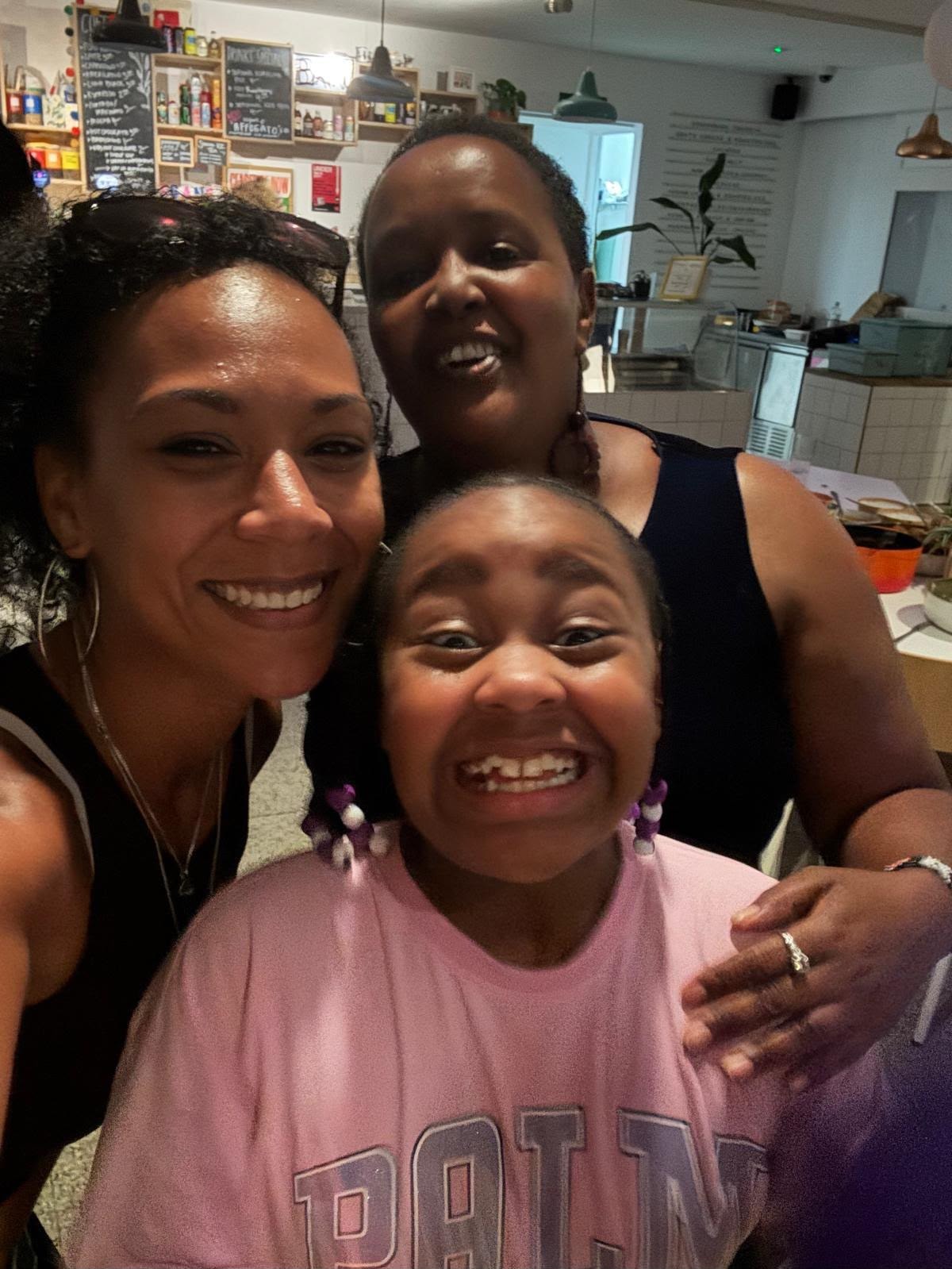 Three smiling community members at the EKing Foundation event