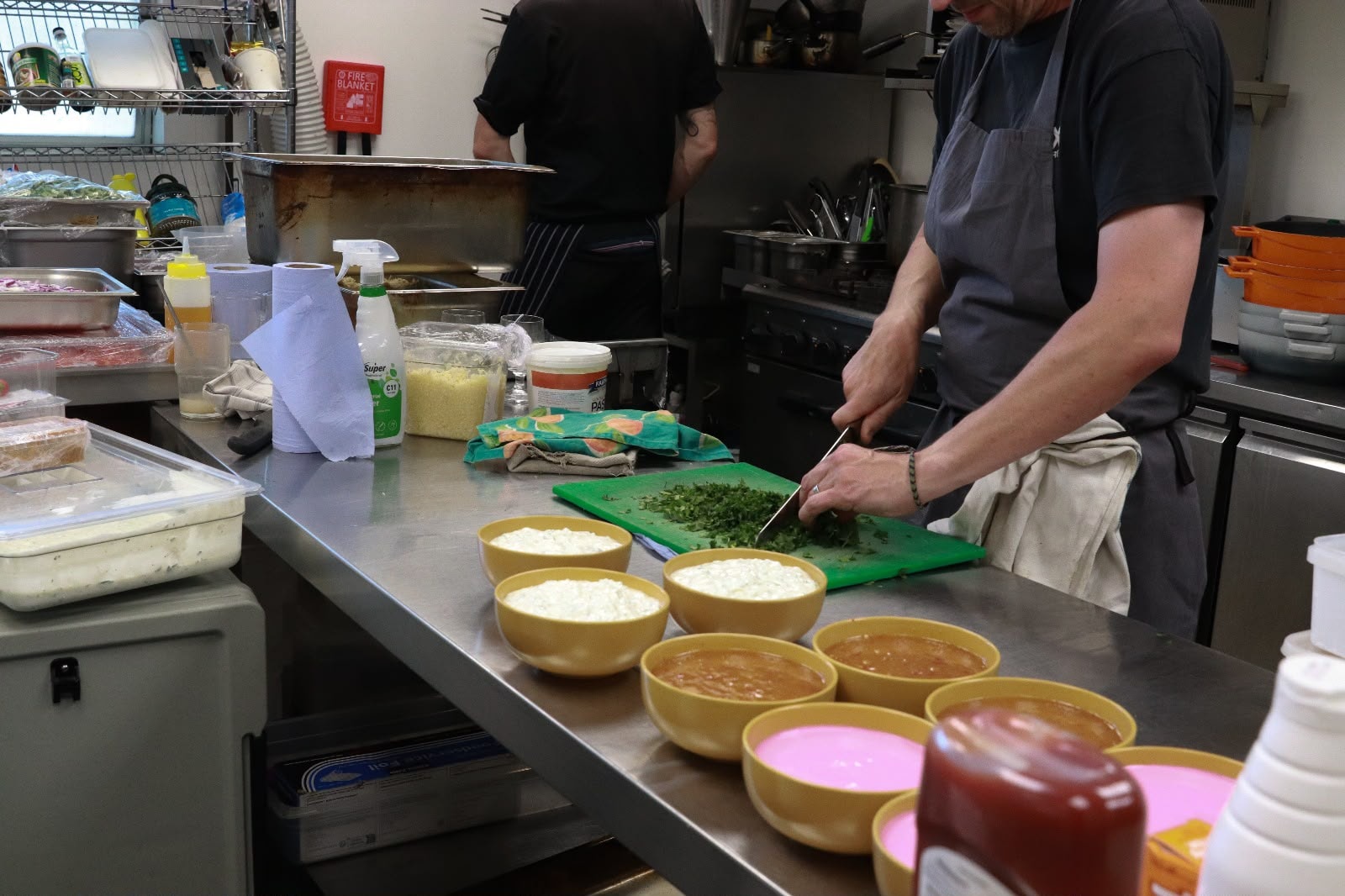 Chef chopping herbs in the kitchen — preparing the feast for the EKing Foundation event