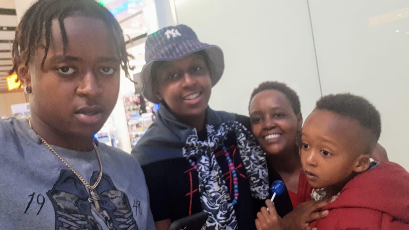 Eddie with friends and a young child — a happy group selfie